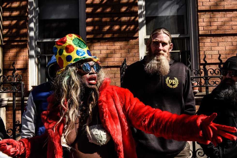 A performance artist stands near a Proud Boy outside of The Center, a support space for LGBTQ+ people on March 19, 2023 in New York City.