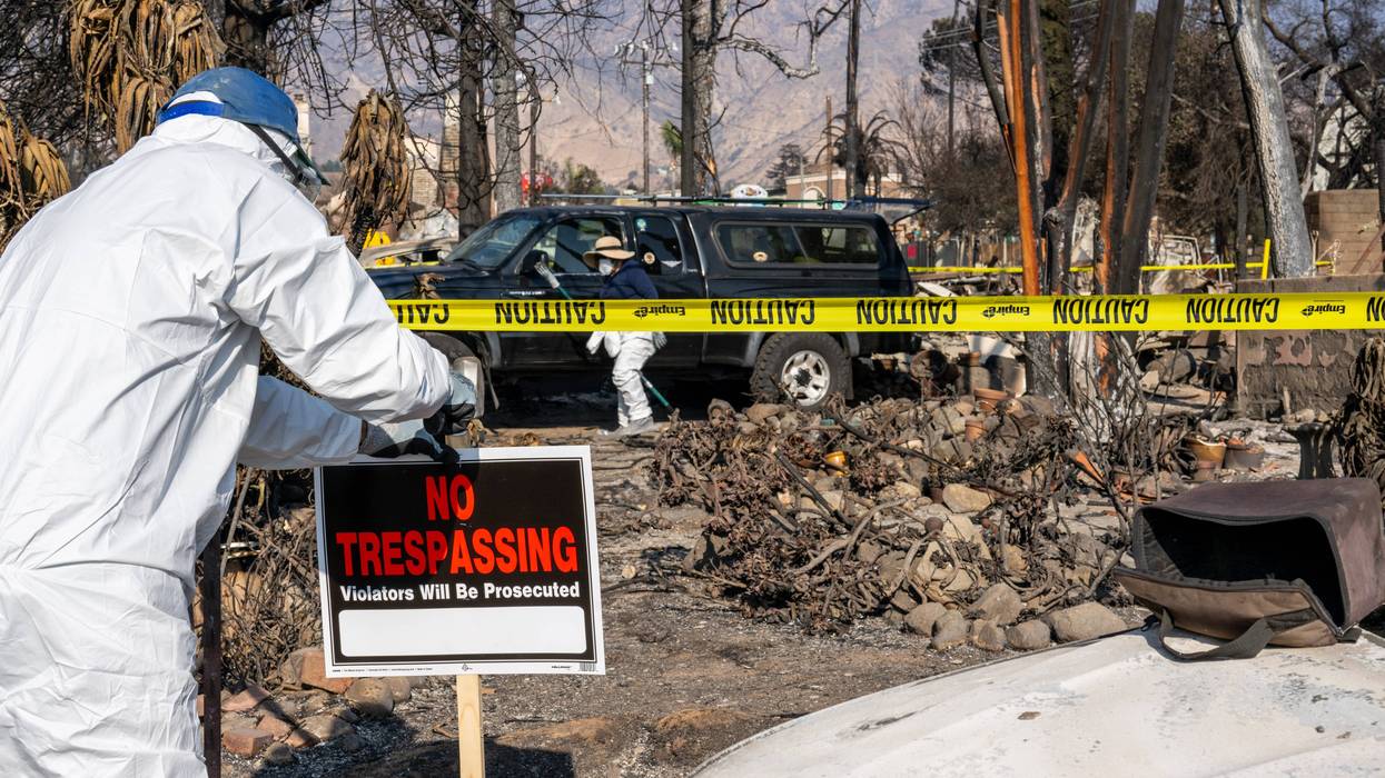 A person erects a "No Trespassing" sign near their property on January 19, 2025 in Altadena, California.