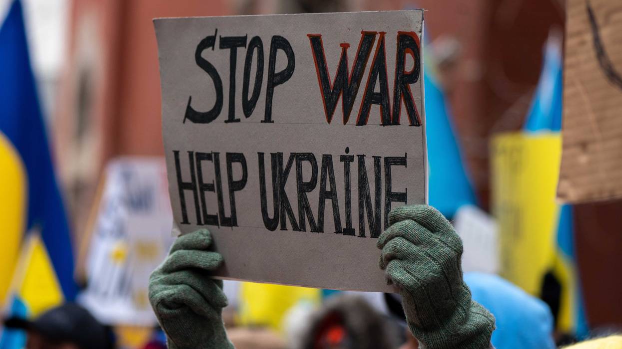 A person holds a sign that reads "Stop War Help Ukraine" during a "Stand With Ukraine" rally at the Russian Mission on February 24, 2022 in New York City.