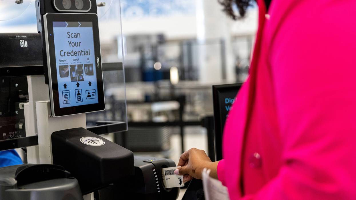 A person inserts an ID card while demonstrating the Transportation Security Administration's new facial recognition technology at a Baltimore-Washington International Thurgood Marshall Airport security checkpoint, Wednesday, April 26, 2023, in Glen Burnie, Md.