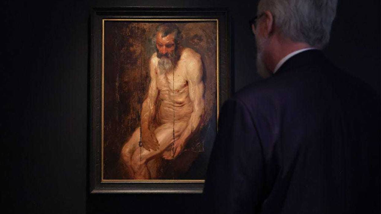 A person looks at Sir Anthony van Dyck's "A study for Saint Jerome" during the Masters Week press preview at Sotheby's New York on January 20, 2023 in New York.