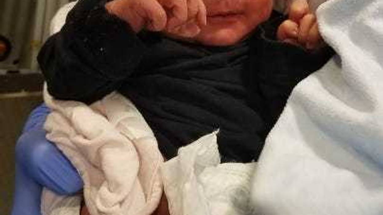 A person of interest was being questioned Friday about a newborn found abandoned in a dresser drawer in a Northwest Side alley earlier this week.