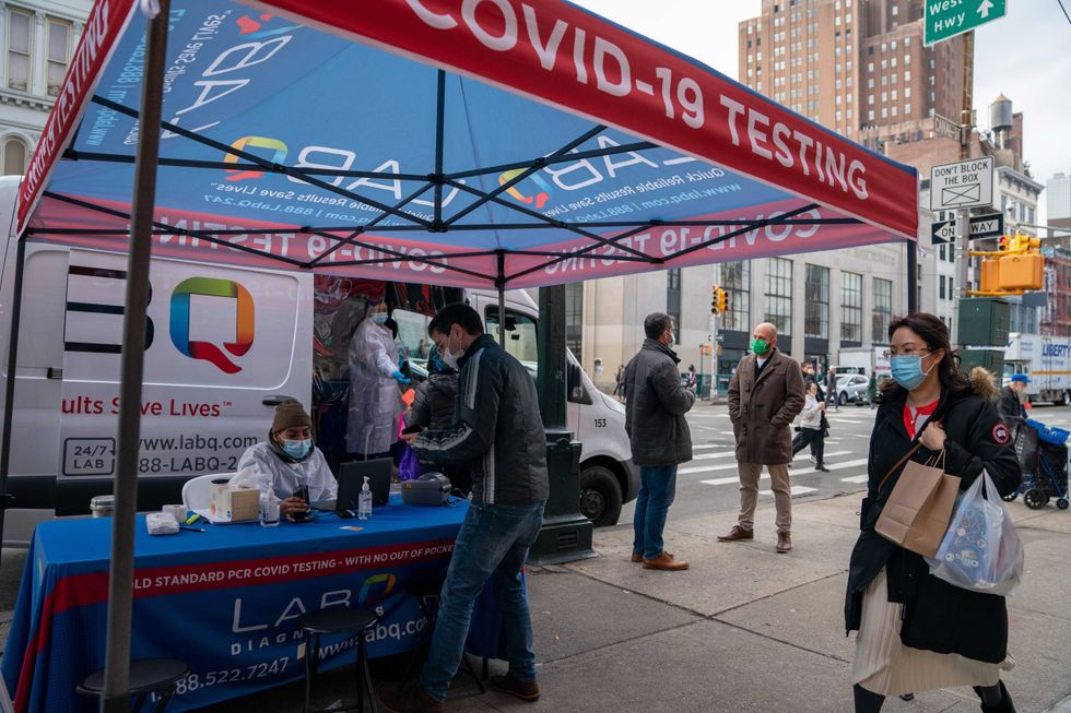 A person registers to have a COVID-19 test administered at a walk-up testing site in Manhattan on Dec. 15, 2021