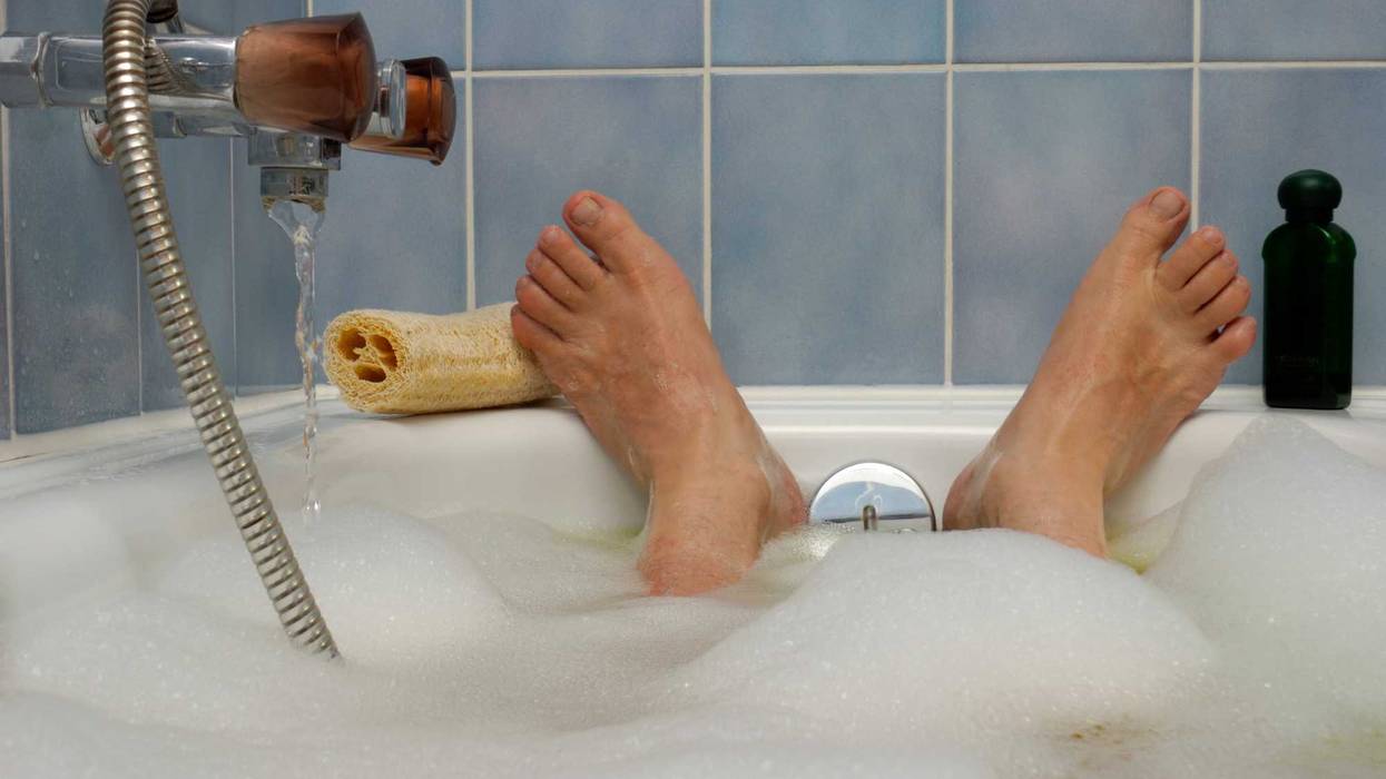 A person's feet in a bathtub.