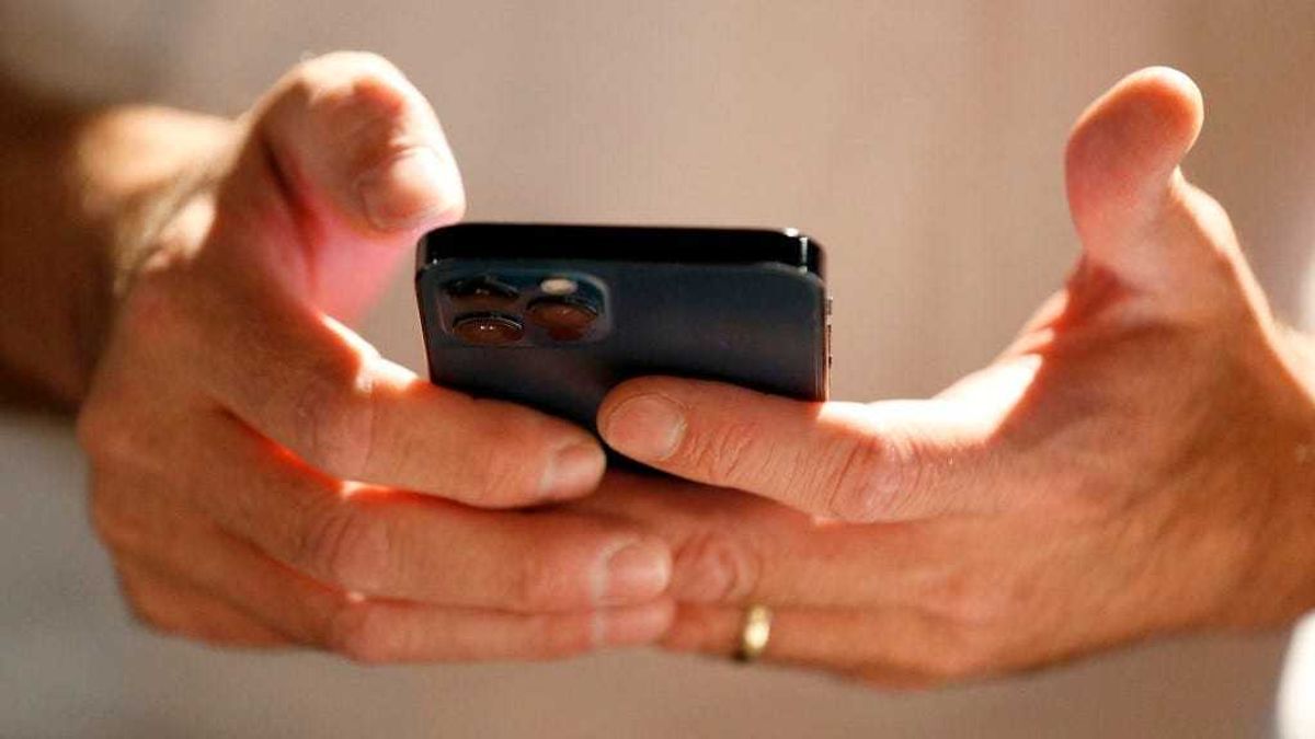 A person scans and downloads an app to start the process of converting their physical driver license to an official digital version to be stored on a mobile phone at a Harmons Grocery store on August 4, 2021 in Salt Lake City, Utah.