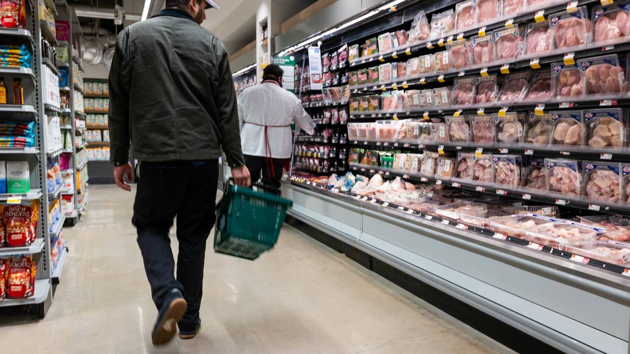 A person shops at a Whole Foods Market grocery store.