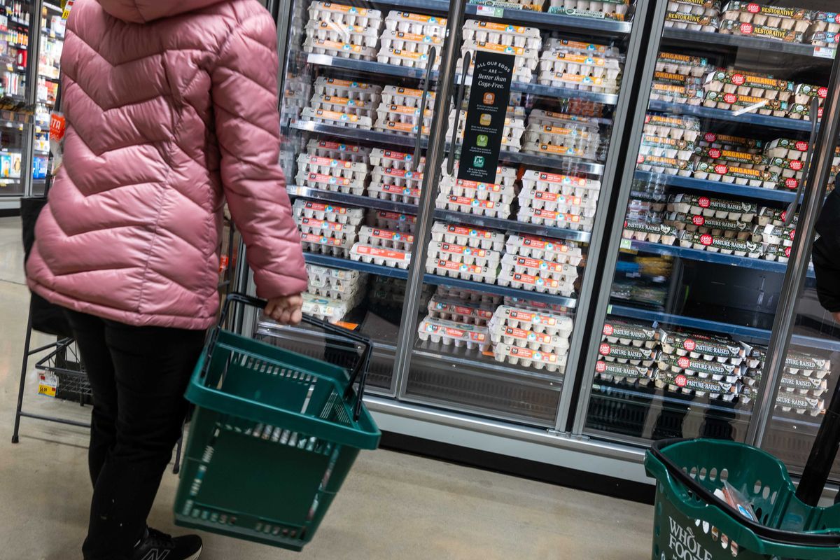 A person shops for eggs at a Whole Foods Market grocery store in December. Grocery prices have recently seen their most significant monthly gain since January of 2023 with egg prices rising 8.2% alone.