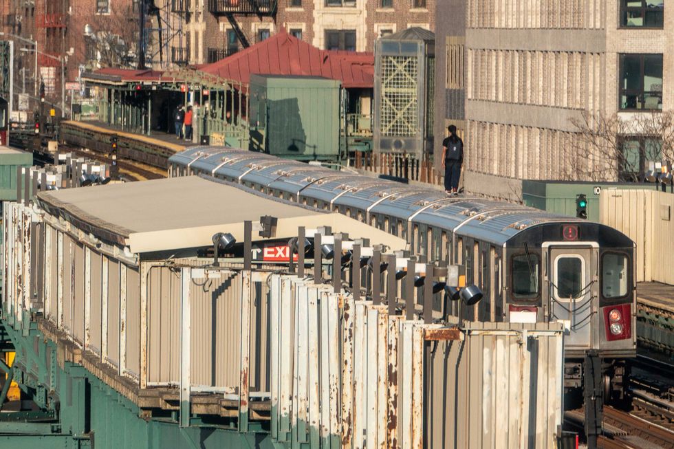A person stands on a 5 train on March 16, 2023, in the Bronx