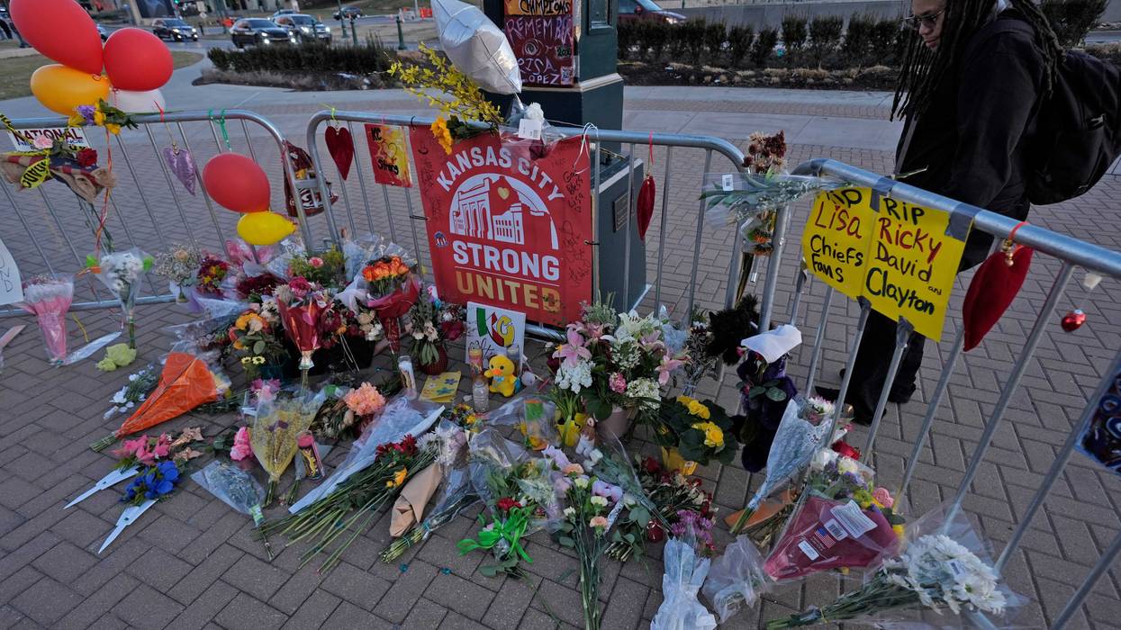 A person views a memorial dedicated to the victims of last week's mass shooting in front of Union Station, Sunday, Feb. 18, 2024, in Kansas City, Mo.