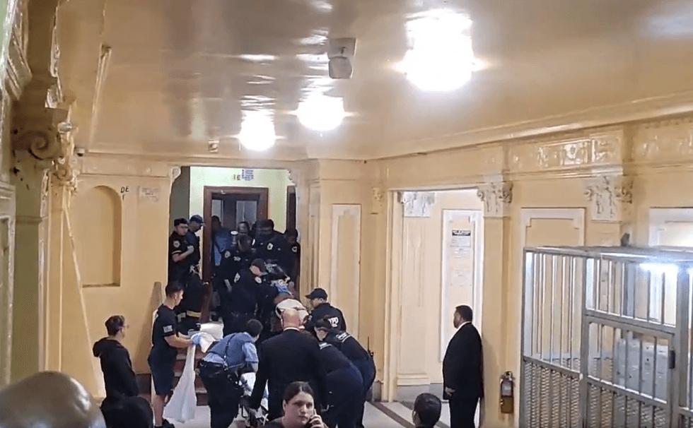 A person was wheeled out of an apartment building in Flatbush on a stretcher following a police-involved shooting on Friday.