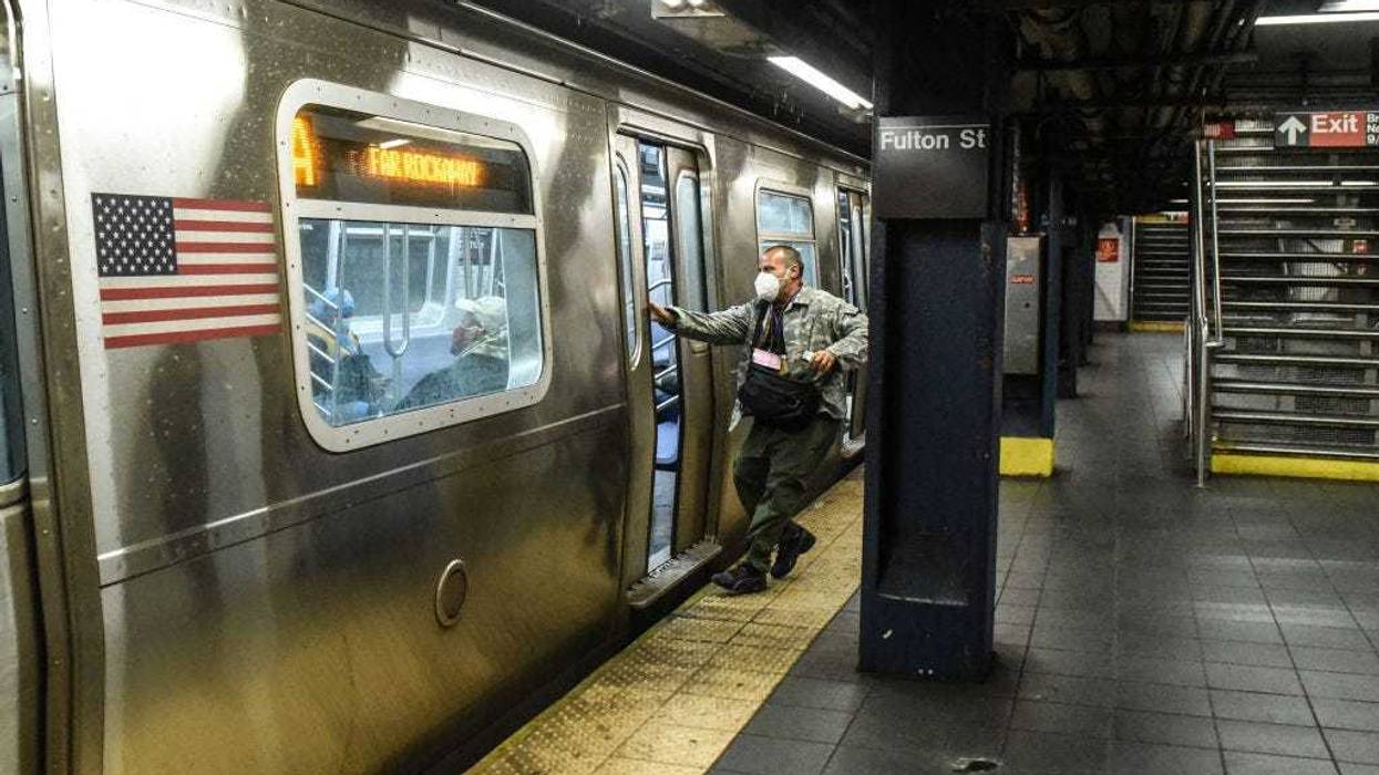 A person wears a protective mask while trying to catch a train in the Fulton St. station on May 6, 2020 in Manhattan in New York City.