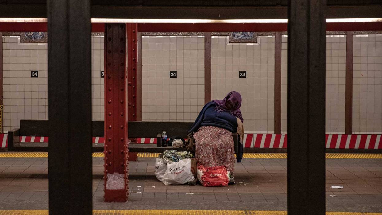 A person with bags of belongings sleeps on a 34th Street subway platform on April 28, 2020 in New York City.