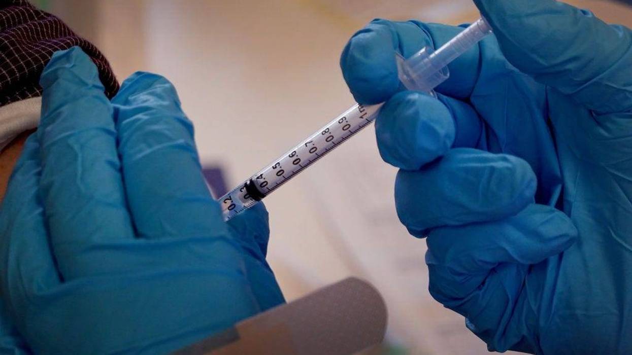 A pharmacist gives a COVID-19 vaccine booster shot during an event hosted by the Chicago Department of Public Health at the Southwest Senior Center on September 09, 2022 in Chicago, Illinois.