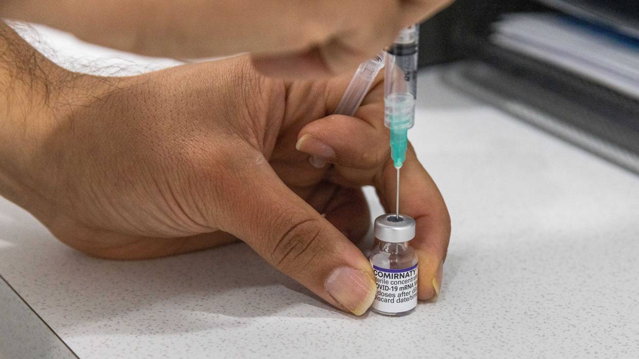A pharmacist is seen preparing a Covid-19 vaccine at the Pharmacy 4 Less M-City Clayton on July 11, 2022 in Melbourne, Australia.
