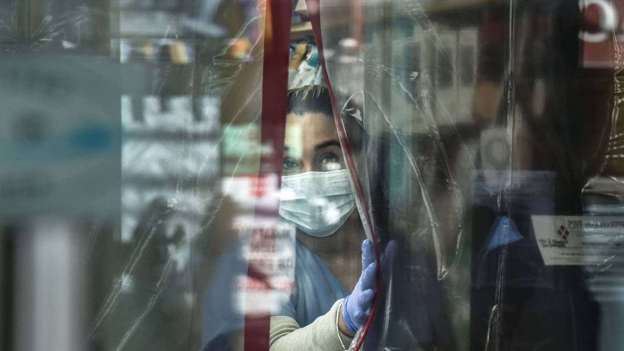 A pharmacist works while wearing personal protective equipment in the Elmhurst neighborhood on April 1, 2020 in New York City. With more than 75,000 confirmed cases of COVID-19 and more than 1,000 deaths, New York City has become the epicenter of the outbreak in the United States.