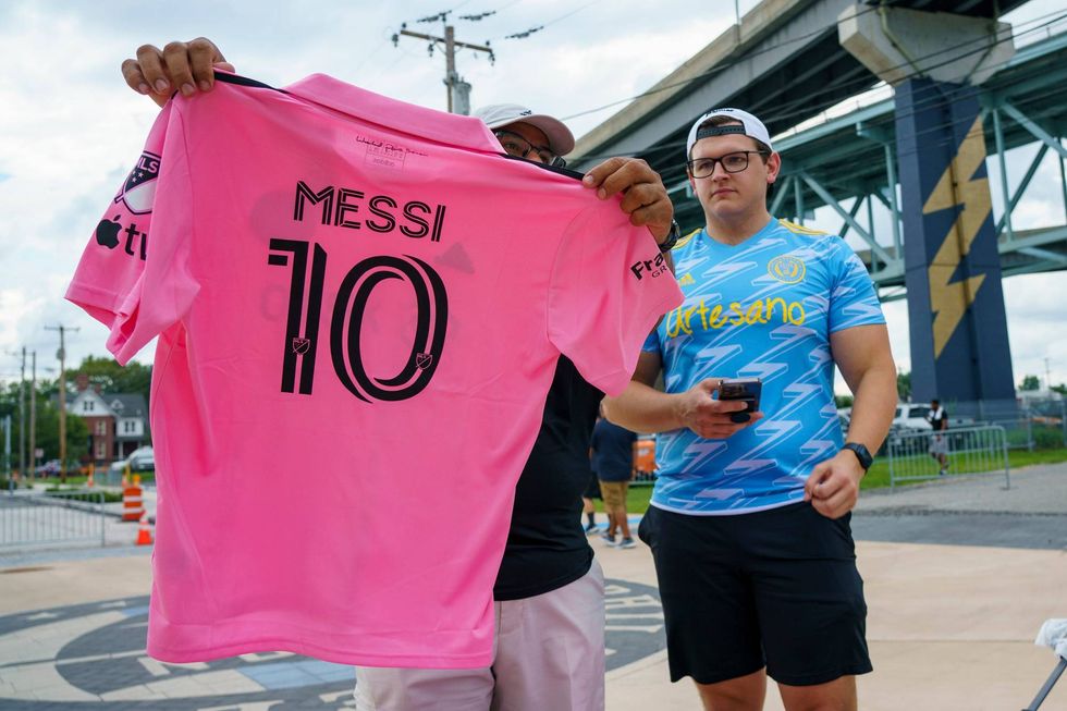 A Philadelphia Union fan looks over an Inter Miami Lionel Messi jersey before a Leagues Cup soccer semifinal Tuesday, Aug. 15, 2023, in Chester, Pa.