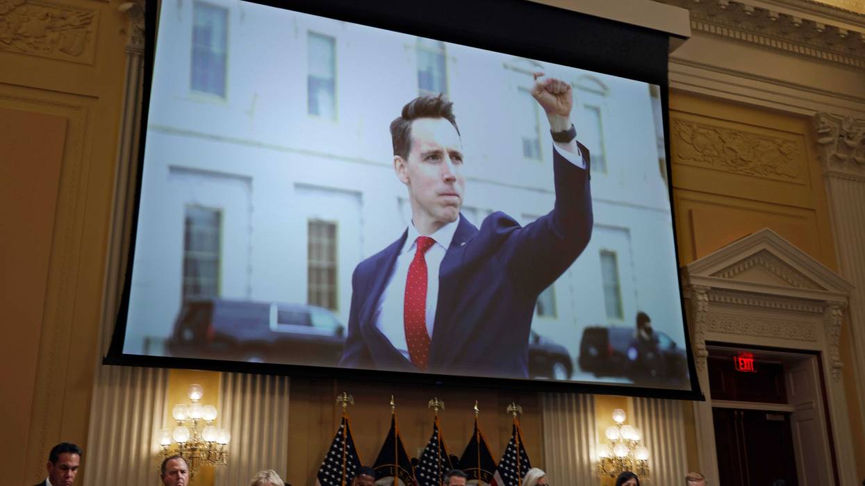 A photograph of Sen. Josh Hawley (R-MO) pumping his fist toward the rioters on January 6, 2021 is shown during a prime-time hearing of the House Select Committee to Investigate the attack on the U.S. Capitol the Cannon House Office Building on July 21, 2022 in Washington, DC.
