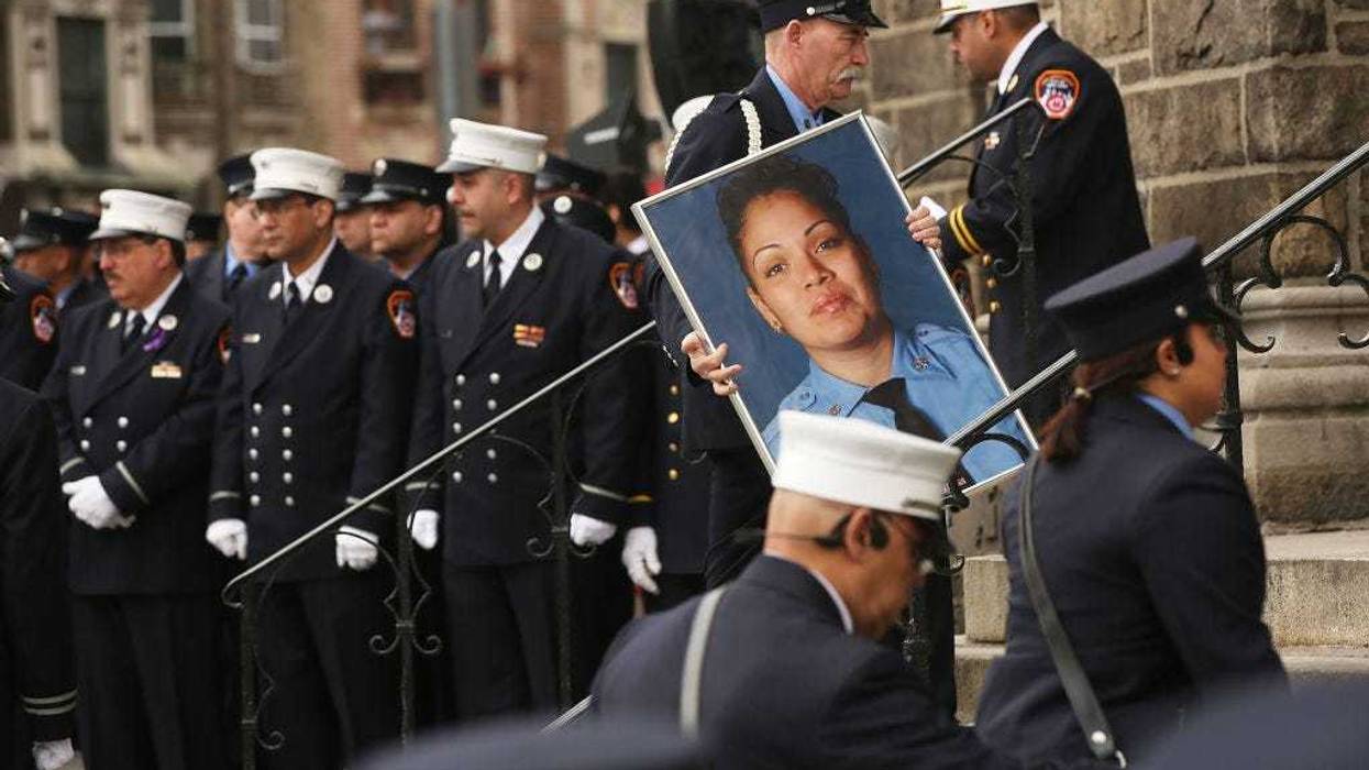 A picture of New York City fire department (FDNY) EMT Yadira Arroyo is brought into St. Nicholas of Tolentine R.C. Church in the Bronx during her funeral on March 25, 2017 in New York City. Arroyo, a 14-year veteran with the fire department, was killed when a man managed to get behind the wheel of her ambulance and ran her over.