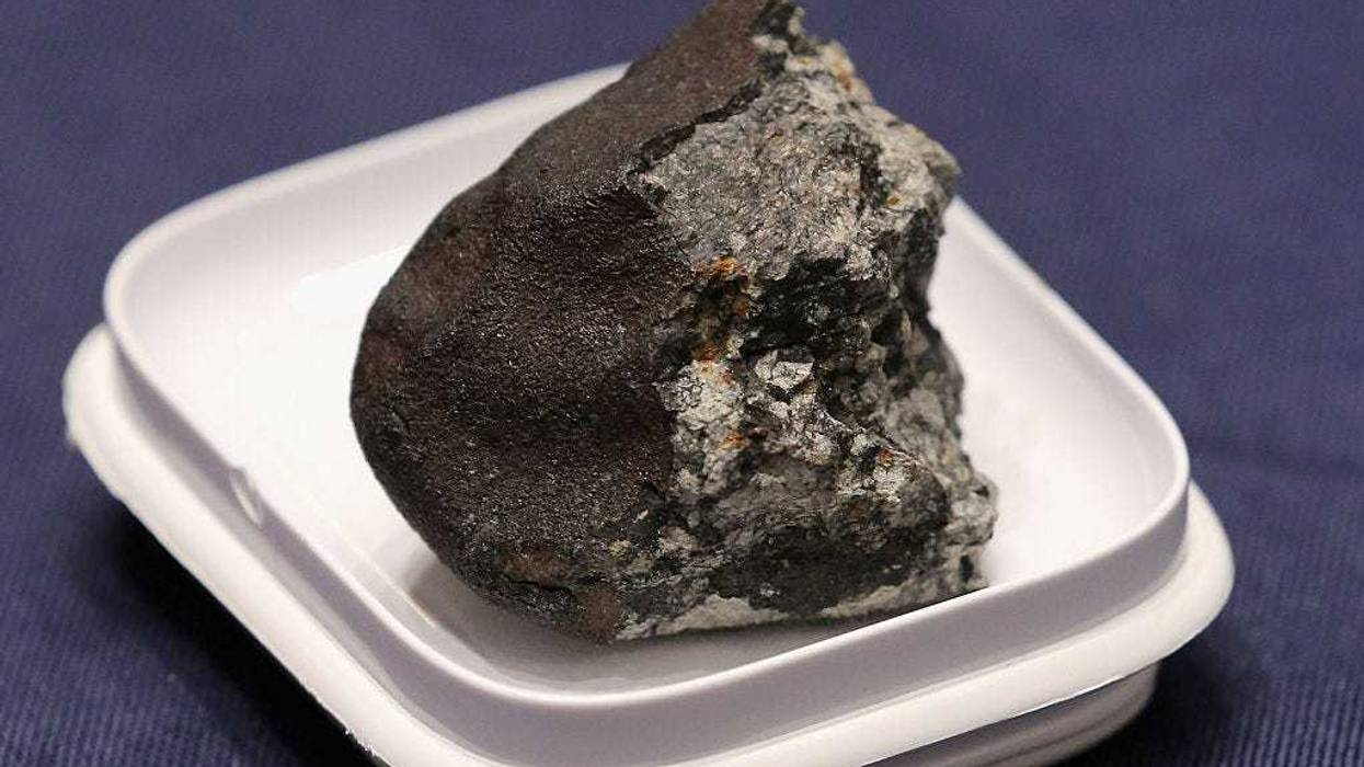 A piece of the Chelyabinsk meteorite is displayed before a hearing of the House Administration Committee in the Longworth House Office Building on Capitol Hill June 17, 2015 in Washington, DC. Famously caught by a number of video cameras, the meteorite fell to earth February 15, 2013 and caused a large amount of damage in the city of Chelyabinsk, Russia. (Photo by Chip Somodevilla/Getty Images)