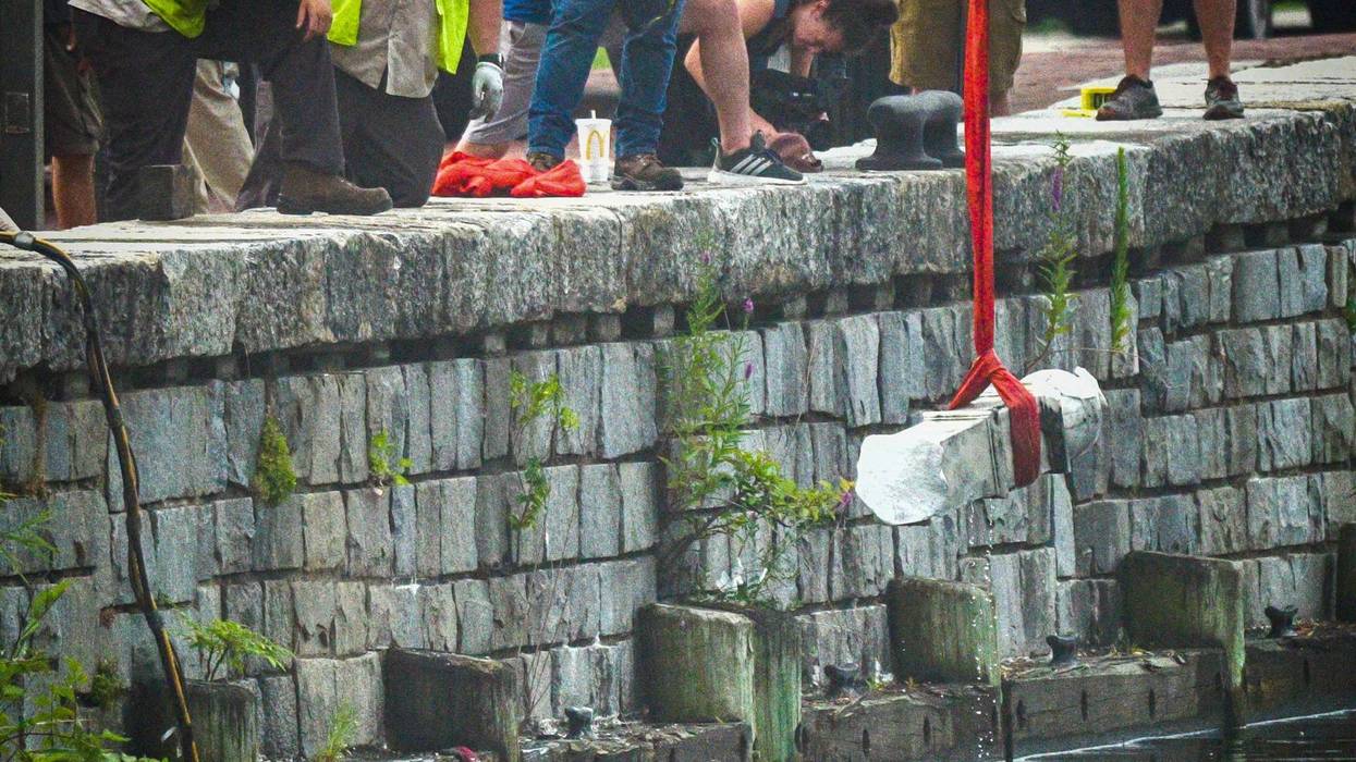 A piece of the Christopher Columbus statue is pulled from the harbor in Baltimore on July 6, 2020. (Jerry Jackson/Baltimore Sun/Tribune News Service via Getty Images)