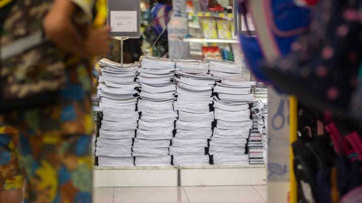 A pile of new notebooks on display in a school supply store
