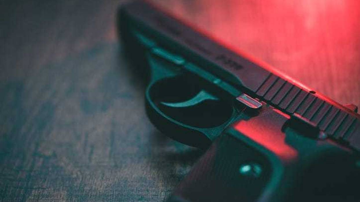 A pistol on a table.