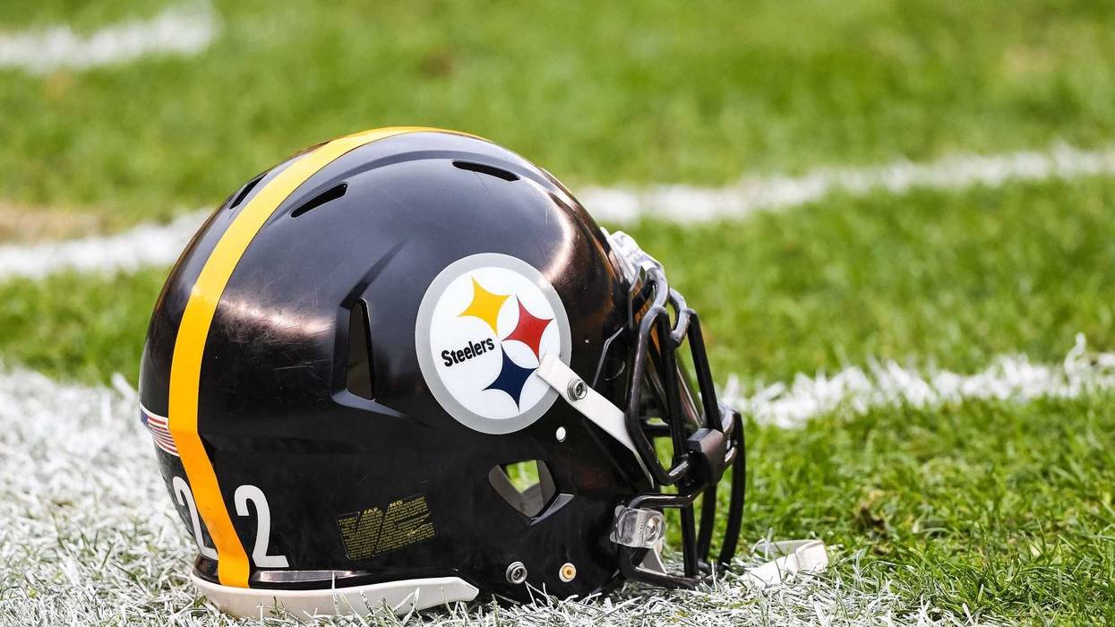A Pittsburgh Steelers helmet sits on the field