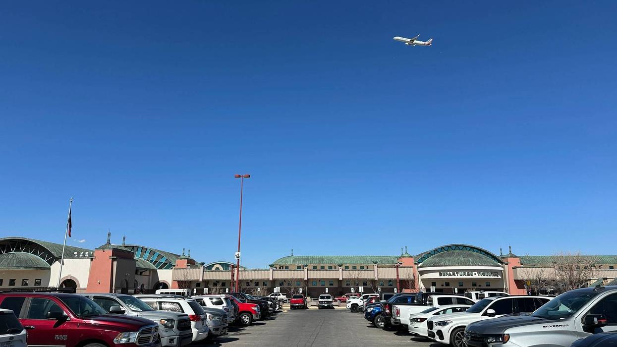 A plane flies over El Paso International Airport, Wednesday, Feb. 11, 2026, in El Paso, Texas