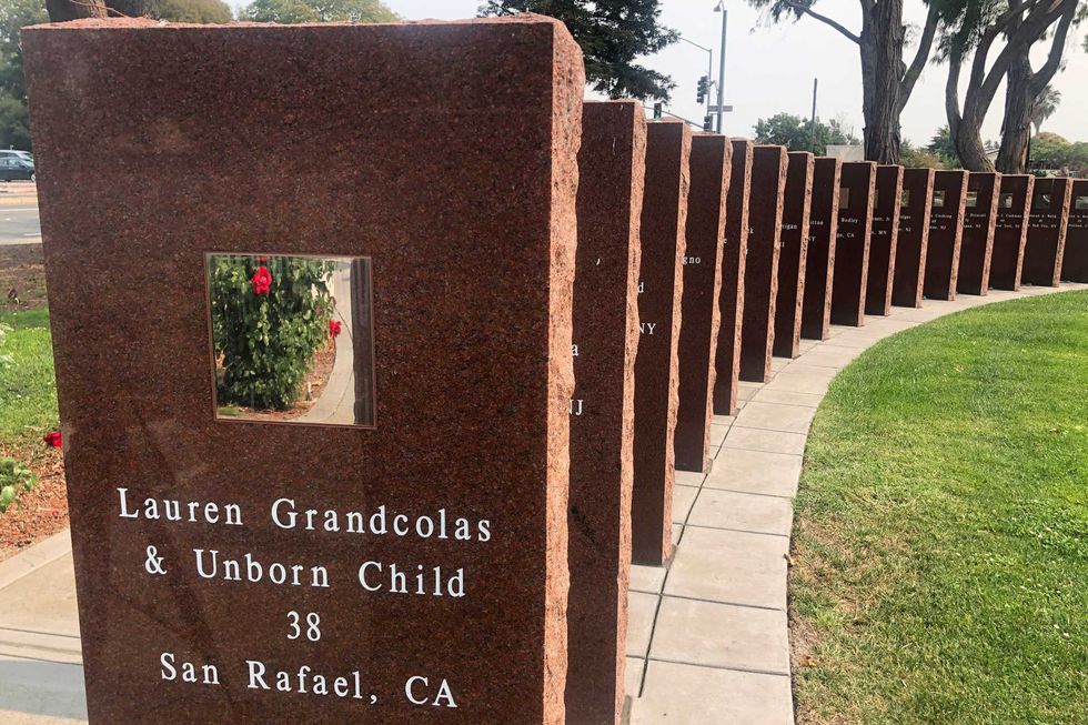 A plaque honors Lauren Grandcolas, who died on United Flight 93, in Union City, Calif., Aug. 17, 2021. Twenty years later, Jack Grandcolas still remembers waking up at 7:03 that morning. He looked at the clock, then out the window where an image in the sky caught his eye — a fleeting vision that looked like an angel ascending. He didn