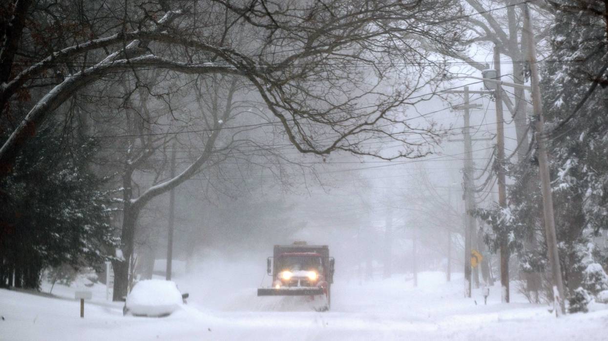A plow drives down Lower Sheep Pasture road shoveling snow during a major snowstorm on January 29, 2022 in Stony Brook, New York.