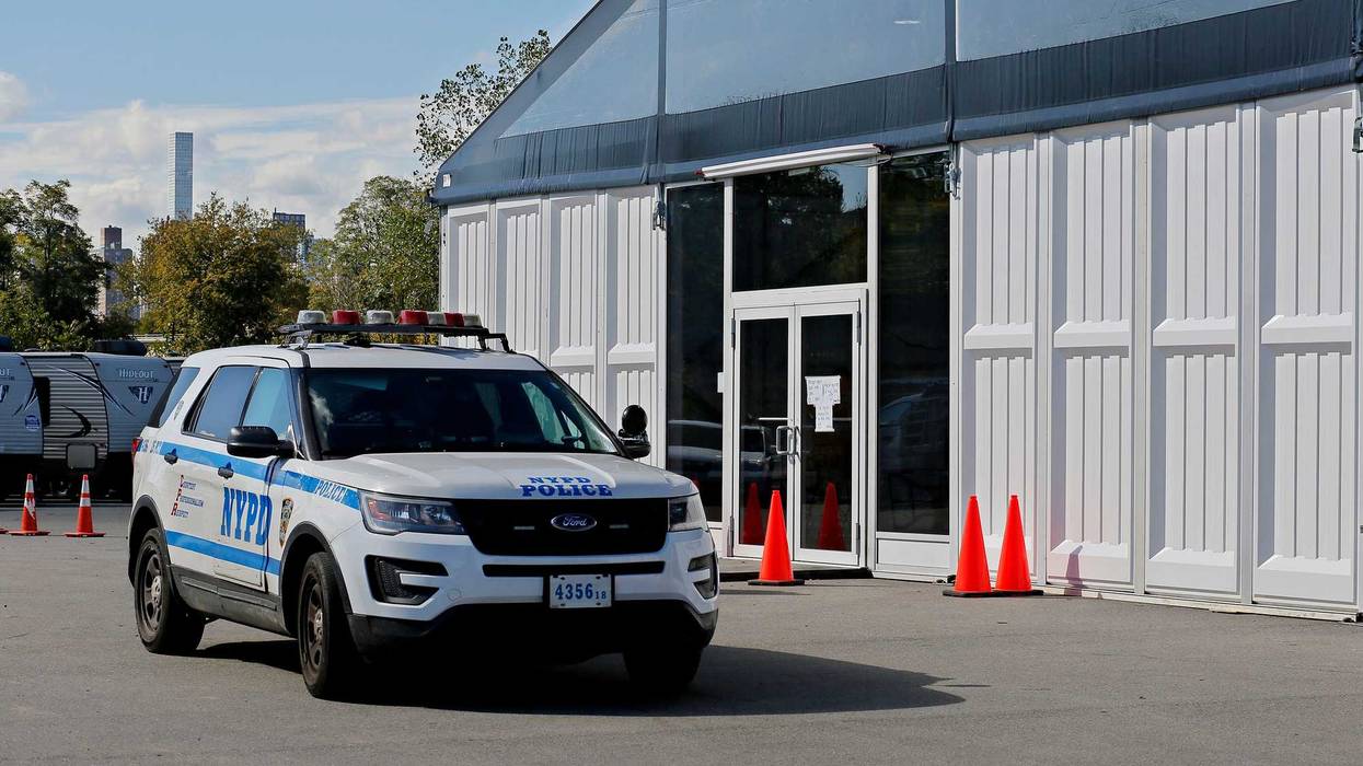 A Police car stands guard at the humanitarian relief center on Randalls Island on October 19, 2022 in New York City. The Randall's Island humanitarian relief center is intended to serve as a temporary stopover for single adult men who arrive on buses several times per week.
