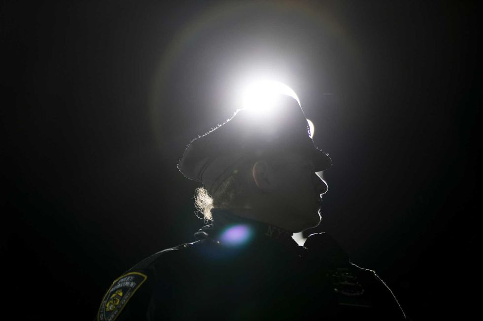 A police officer at the NYPD 71st Precinct looks on during a protest of the police-involved shooting death of Saheed Vassell, in the Crown Heights neighborhood of Brooklyn, April 5, 2018 in New York City. Saheed Vassell, 34, was killed by police officers on Wednesday afternoon in Crown Heights. He was unarmed but was reportedly acting erratic and wielding a curved silver pipe that witnesses thought could have been a gun. (Photo by Drew Angerer/Getty Images)