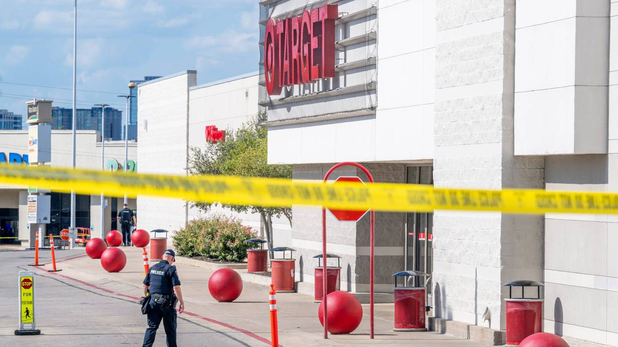 A police officer searches the grounds of a Target store on Aug. 11, 2025, in Austin, Texas.