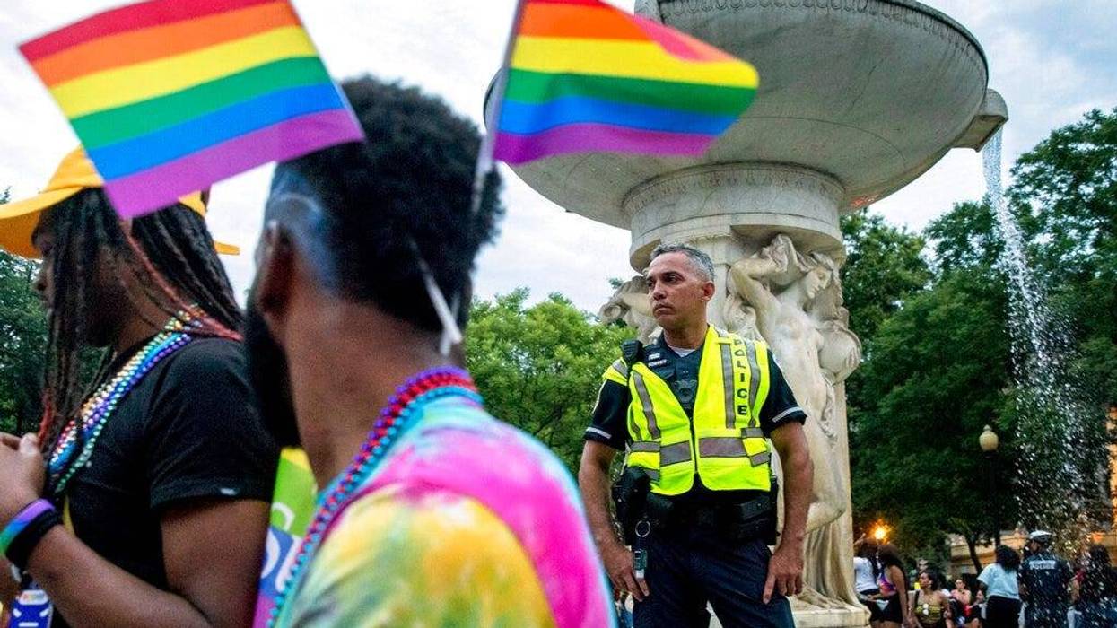 A police officer watches the crowd at the conclusion of the Capitol Pride Parade at Dupont Circle in Washington, Saturday, June 8, 2019.