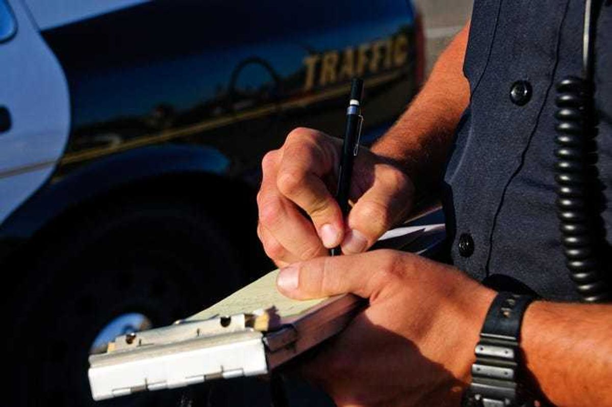 A police officer writing a traffic ticket.