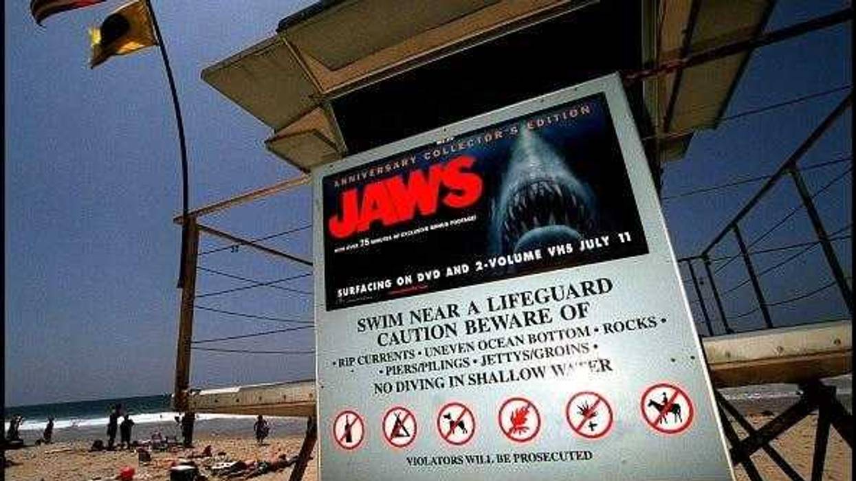 A poster advertising the anniversary collector's edition of the movie "Jaws" is posted on a lifeguard tower June 2, 2000 on Zuma Beach in Malibu, CA. The sign has led to complaints by beach goers with young children, who feel that it is inappropriate for the sign to be on display so close to the water and so near the 4th of July. (Photo by Dan Callister/Newsmakers).