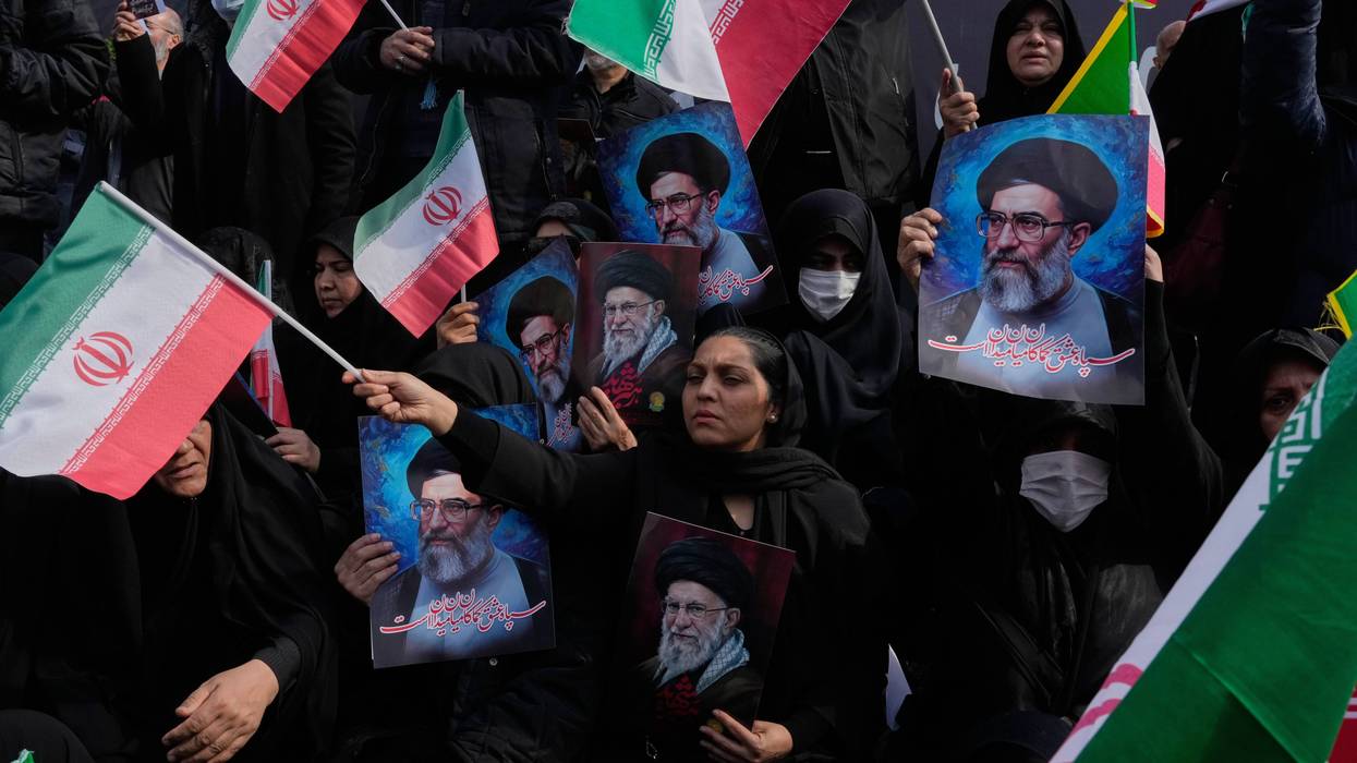 A poster of Ayatollah Mojtaba Khamenei, the successor to his late father Ayatollah Ali Khamenei as supreme leader is placed on an anti-riot police car as policemen stand on top of the car, during a rally to support him in Tehran, Iran, Monday, March 9, 2026.