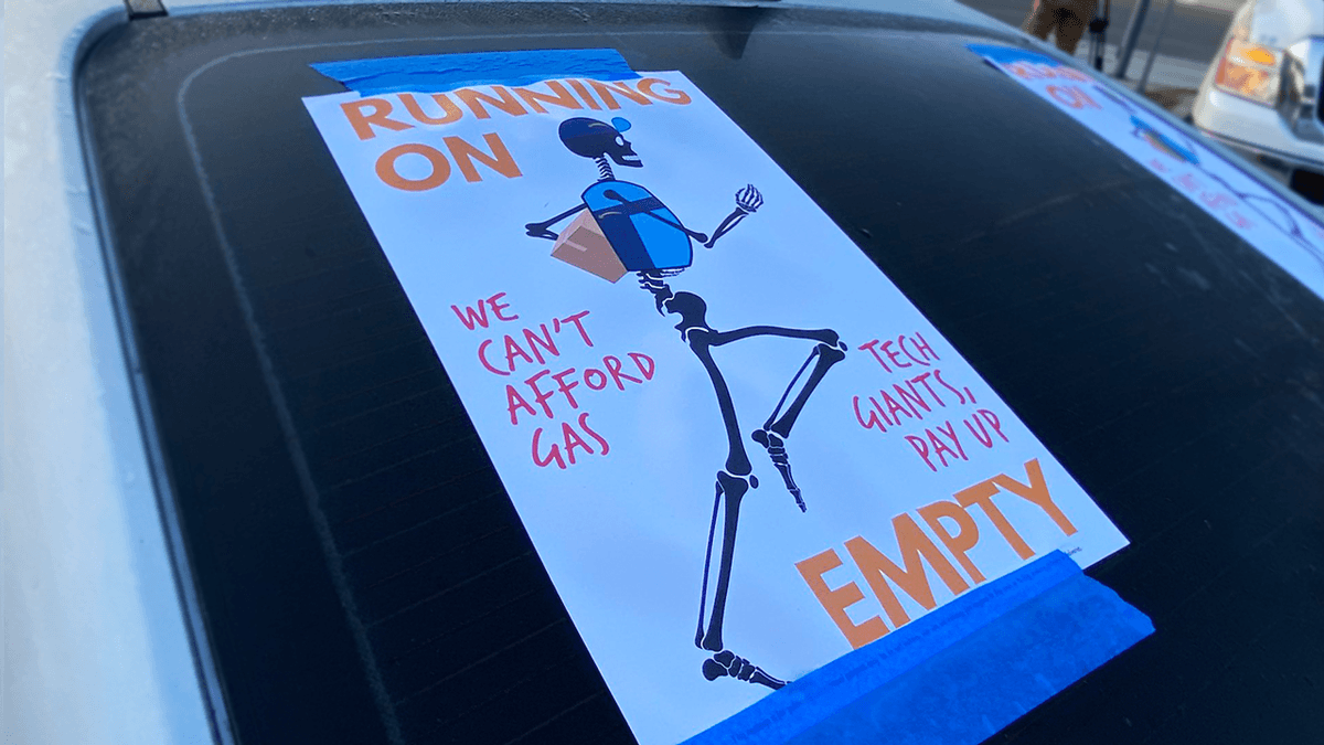 A poster taped to the back of a rideshare driver's car on March 16, 2022 in Redondo Beach, as drivers participated in a rally to protest for more help from Uber, Lyft and Amazon as gas prices continue to skyrocket.