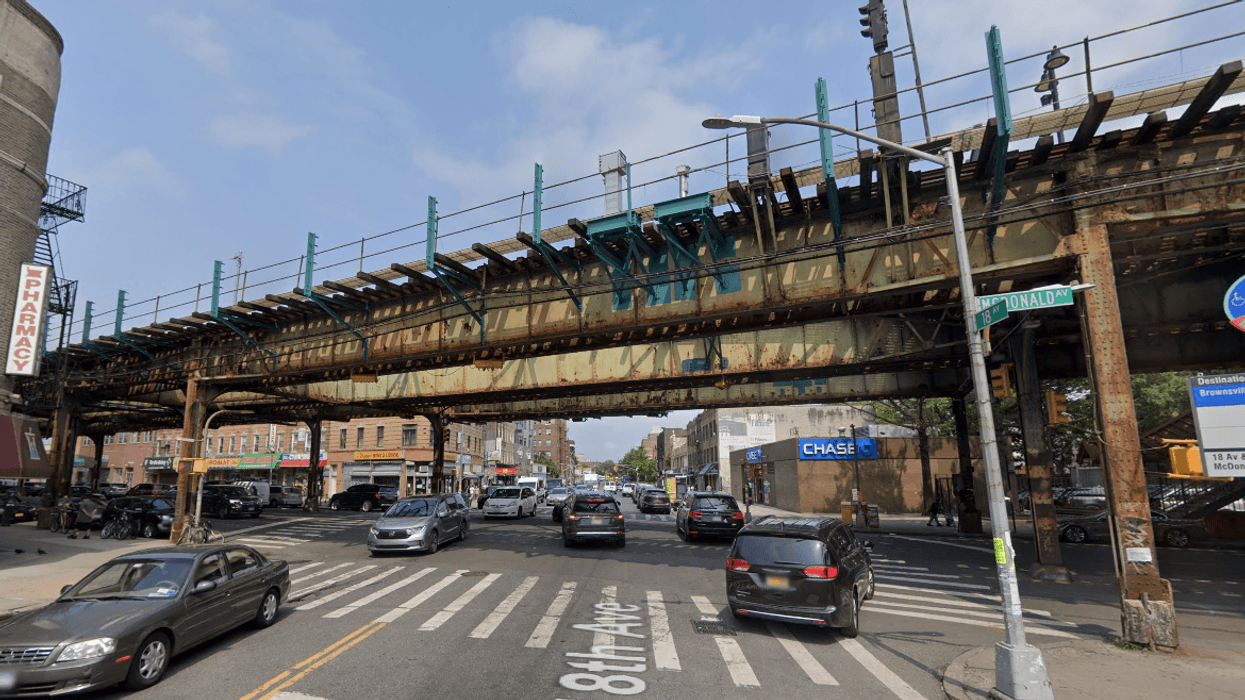 A private sanitation truck collided with a pillar supporting the elevated 18th Avenue station in Borough Park early Wednesday