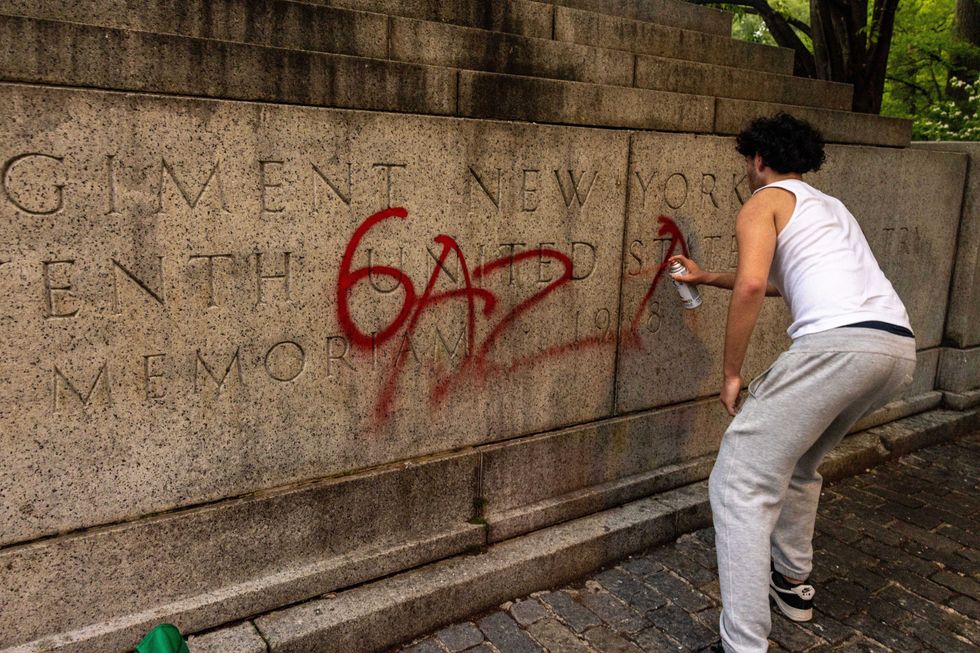 A pro-Palestine protestor writes Gaza on a memoriam near Central Park during a march on the outskirts of the Met Gala on May 6, 2024 in New York City