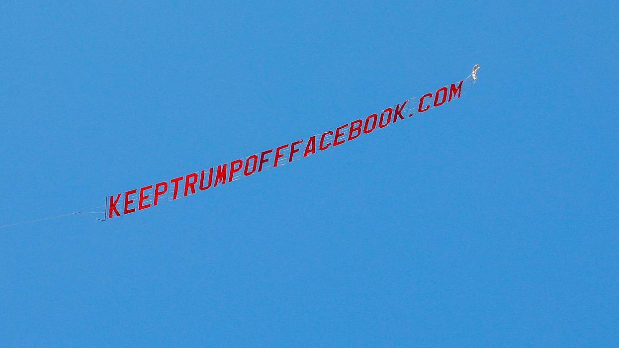 A prop plane flies a banner reading "KEEPTRUMPOFFFACEBOOK.COM" overhead at Facebook's Menlo Park headquarters in California on June 15.