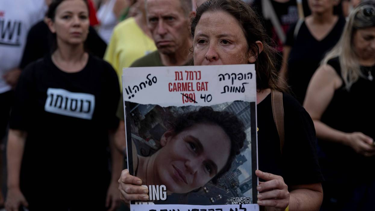 A protester holds a photo of slain hostage Carmel Gat, killed in captivity in Gaza during a rally calling for an immediate hostage deal and release of hostages held by Hamas in the Gaza Strip on Sept. 2, 2024, in Tel Aviv, Israel.