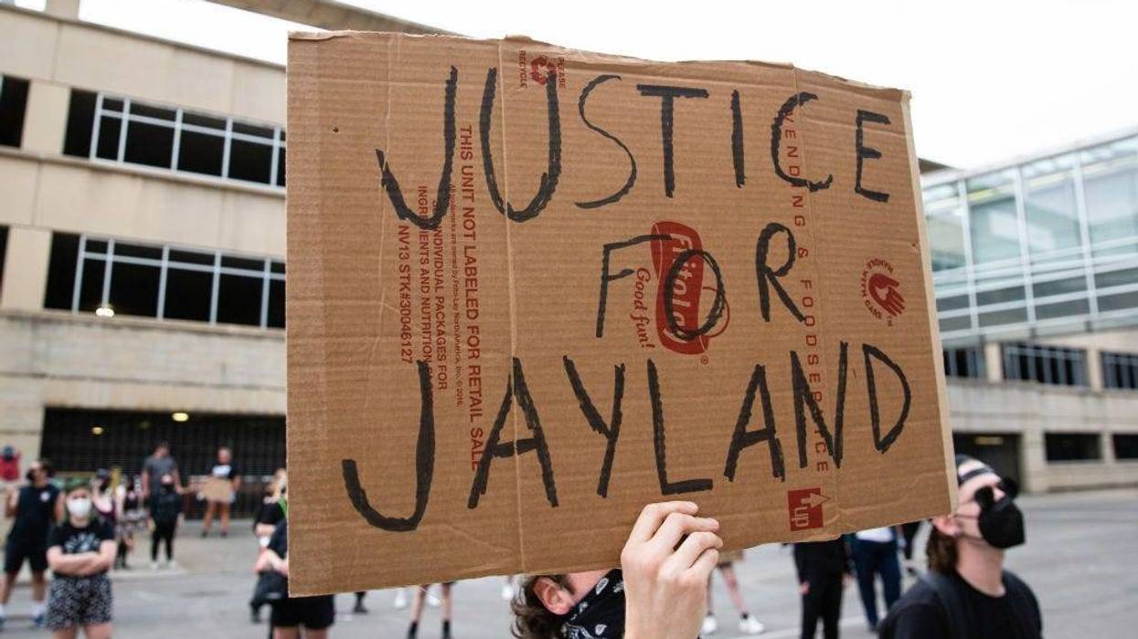 A protester holds a sign that says, "Justice for Jayland Walker" during the demonstration. Hundreds of protesters gather to call for justice in the police killing of Jayland Walker. Due to this protest, Mayor Dan Horrigan declared a state of emergency and canceled the Fourth of July fireworks.