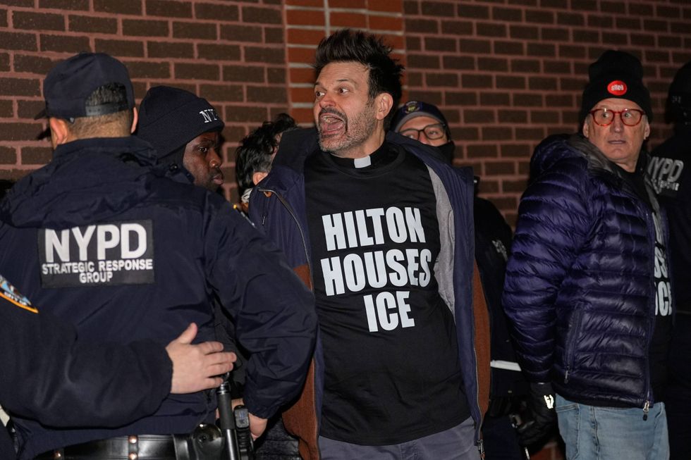 A protesters yells after being arrested for participating in a sit-in at the lobby of a Hilton Garden Inn in New York, Tuesday, Jan. 27, 2026