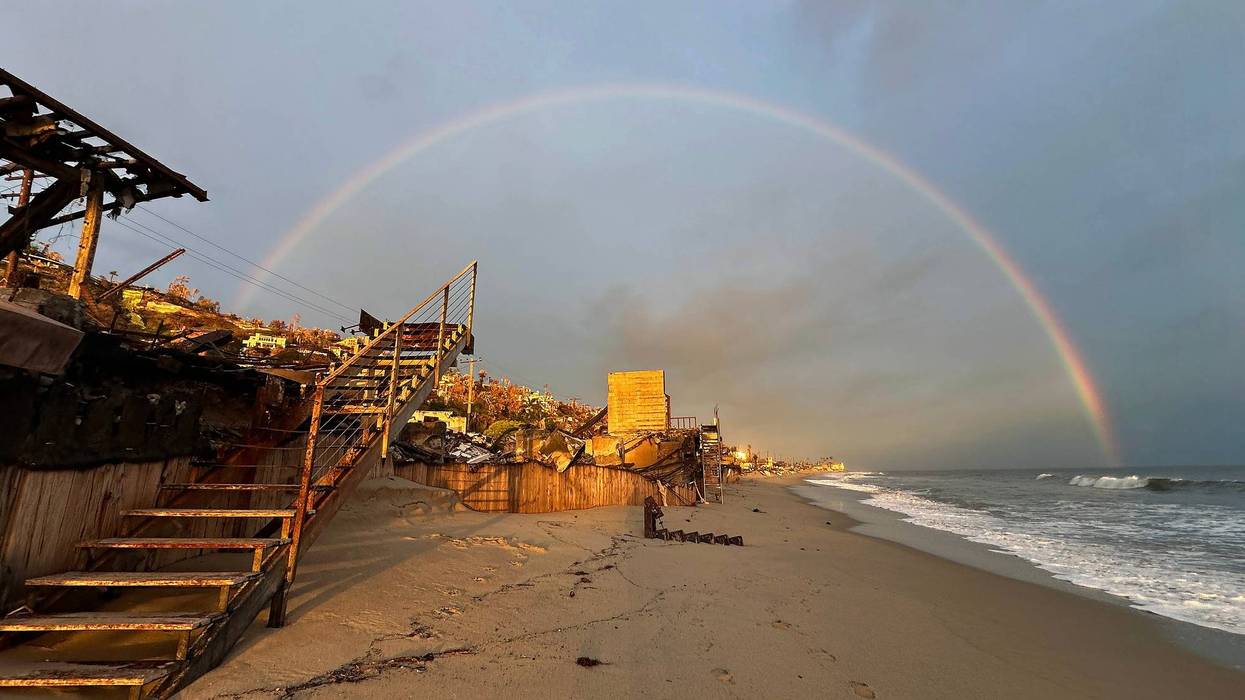 A rainbow appears over beachfront properties destroyed in the Palisades Fire along the Pacific Ocean on March 06, 2025 in Malibu, California.