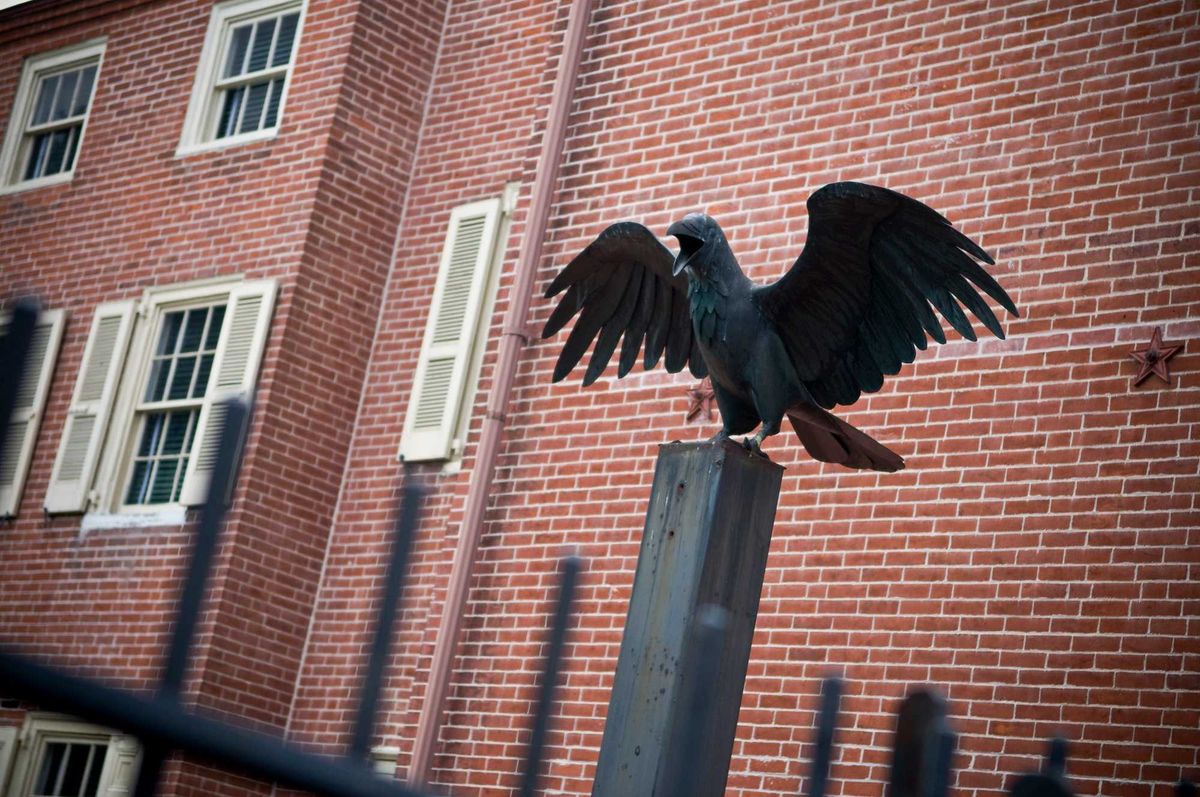 A Raven statue outside the home of Edgar Allen Poe, Famous American poet. The Raven was his most popular poem, the statue signifies that fact.