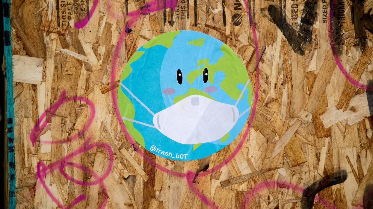 A recently painted mural of a world and a mask is displayed on a board during the coronavirus pandemic on May 03, 2020 in San Francisco, California.