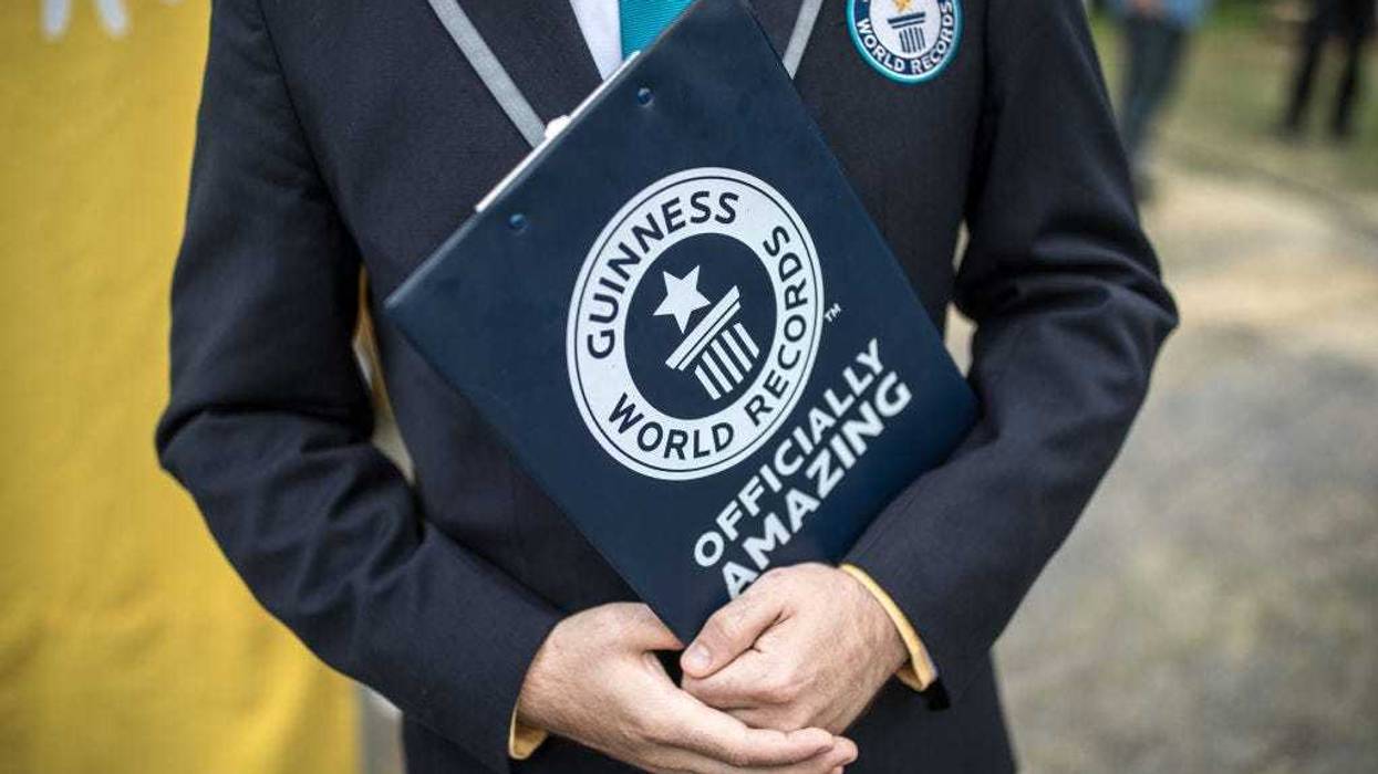 A representative from the Guinness Book of World Records Jack Brockba stands next to the Sandburg sandcastle on September 1, 2017 in Duisburg, Germany.