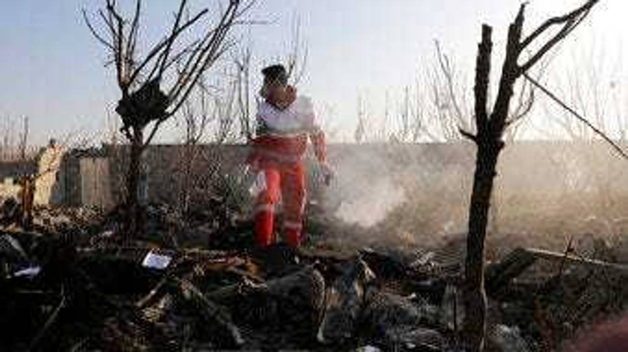 A rescue worker searches the scene where an Ukrainian plane crashed in Shahedshahr, southwest of the capital Tehran, Iran, Wednesday, Jan. 8, 2020. (AP Photo/Ebrahim Noroozi)