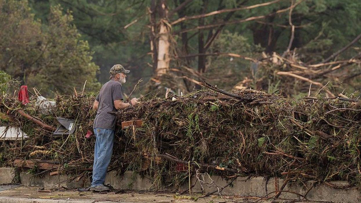 A resident surveys flood damage and debris along the Guadalupe River on July 5, 2025 in Kerrville, Texas.